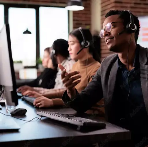 QueueDial call center rep talking on phone next to computer