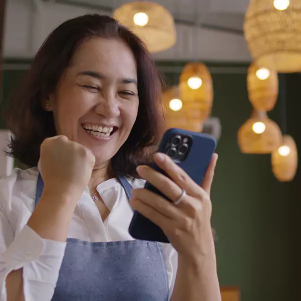 woman happy from the results on her phone